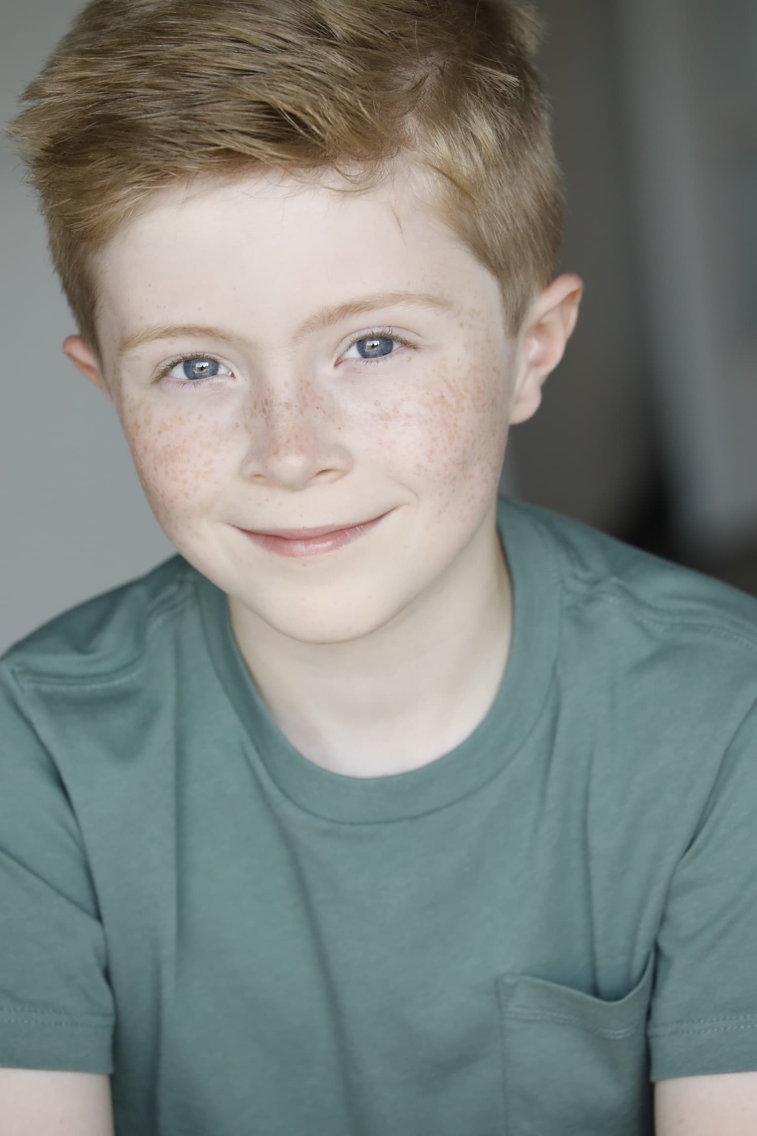 Kaden Stoneking smiling in a green t-shirt, 2025 headshot