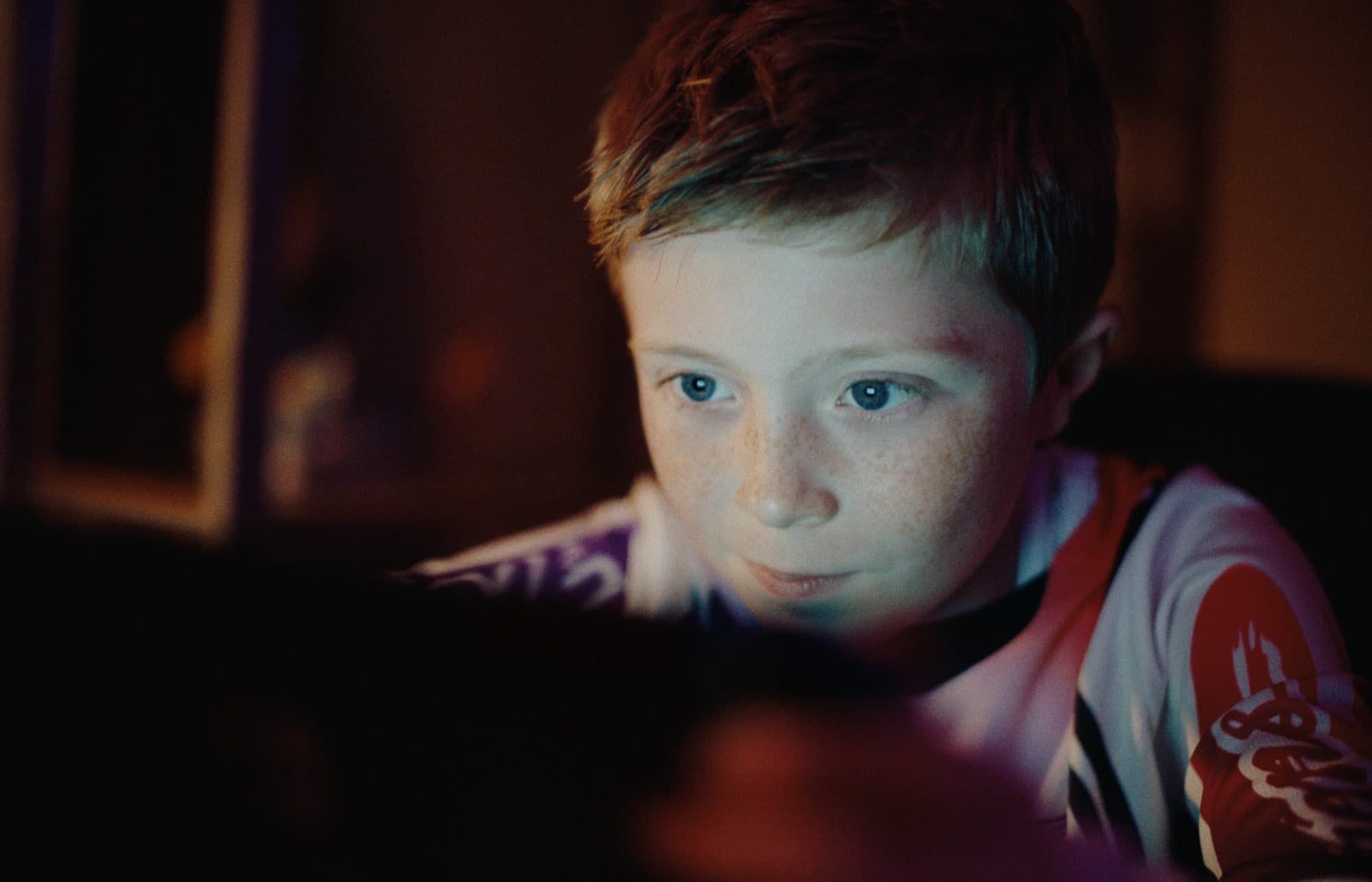 Kaden Stoneking as Willie Valley, lit by a screen, in Elbow Grease