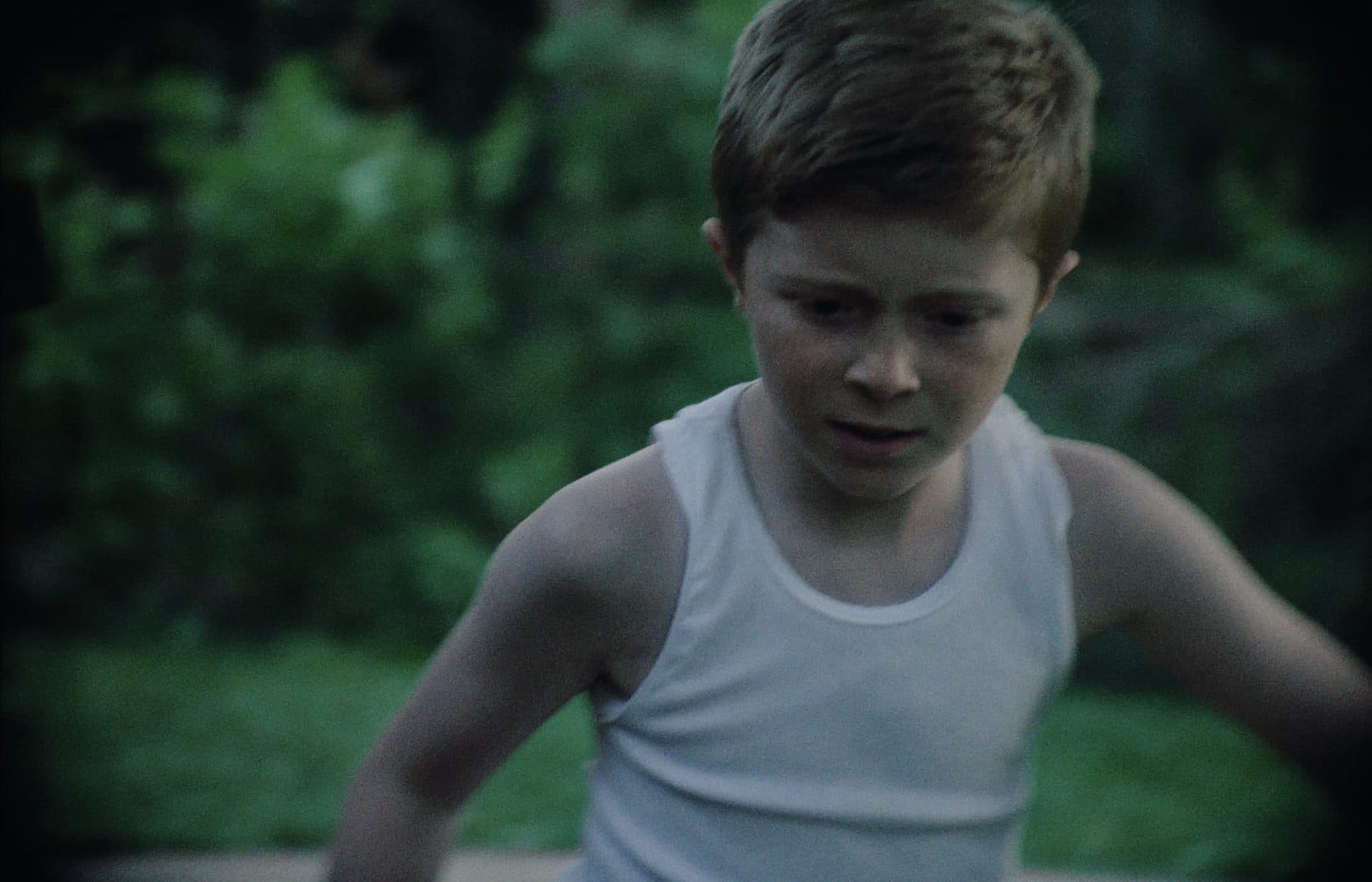 Kaden Stoneking as Willie Valley running through a yard in Elbow Grease